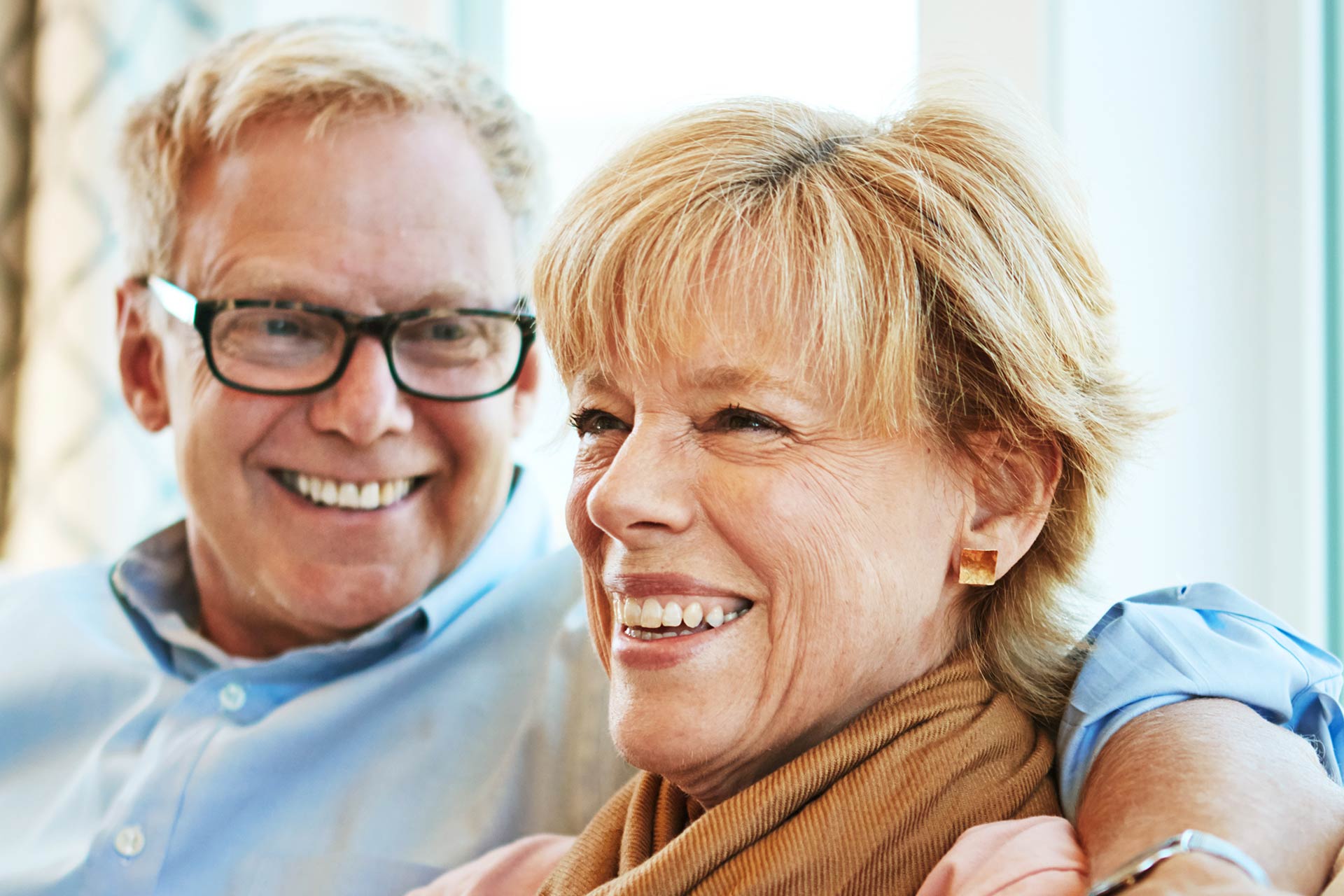 Success & Wellbeing Older Couple smiling - relaxing together is their favorite thing to do