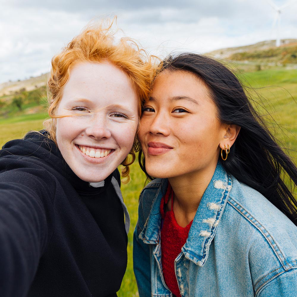 Success & Wellbeing Couples Counseling & Therapy Page Get in Touch Offers Telehealth in New York, Massachusetts & Maine image of two girls taking a selfie