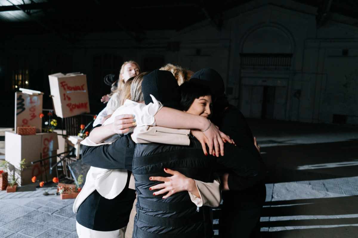 A supportive group hug during a therapy session, symbolizing connection, empathy, and shared healing.