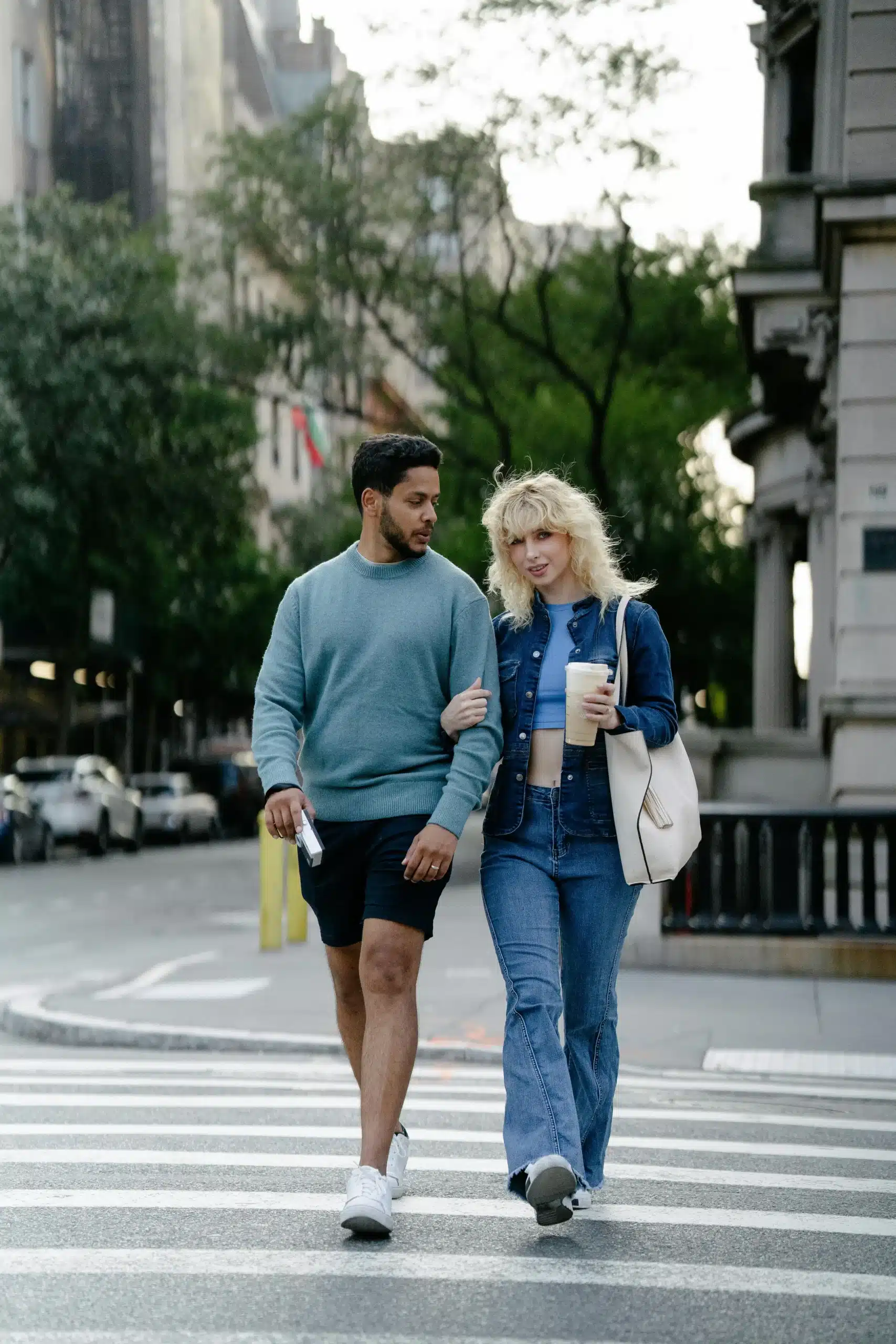 A couple enjoying a walk together on the roadside.
