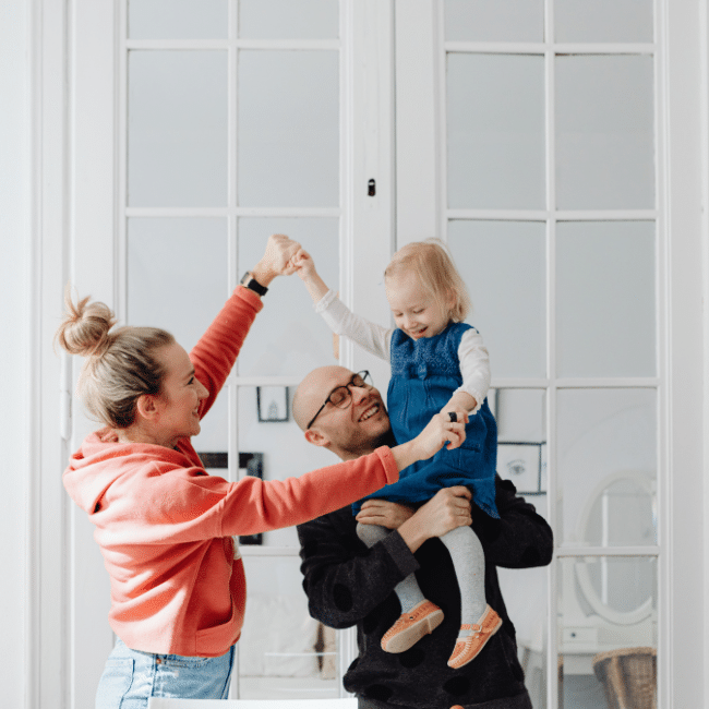 A family playing together, parents and daughter sharing joyful interaction, connection, and emotional bonding time.