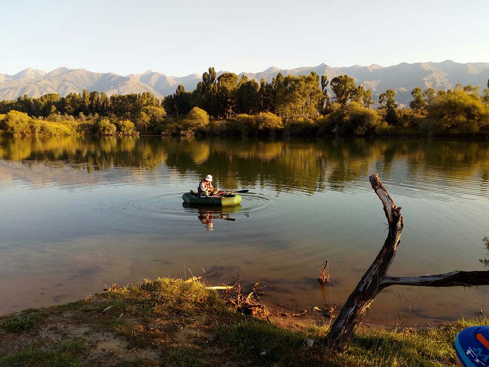 a person in a small boat on a lake