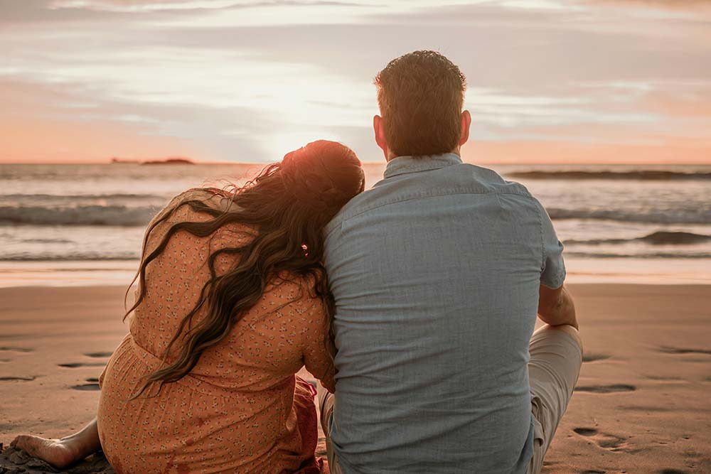 Man and woman sitting on the beach