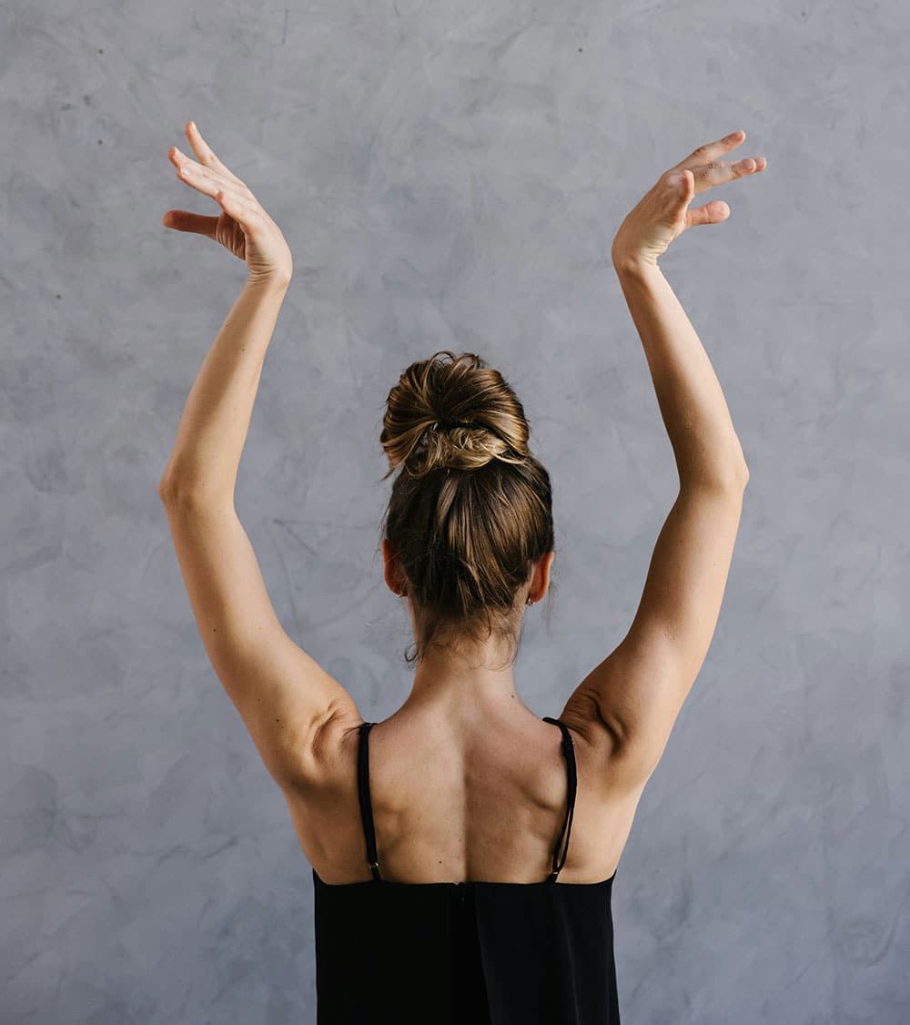 A woman standing with her arms